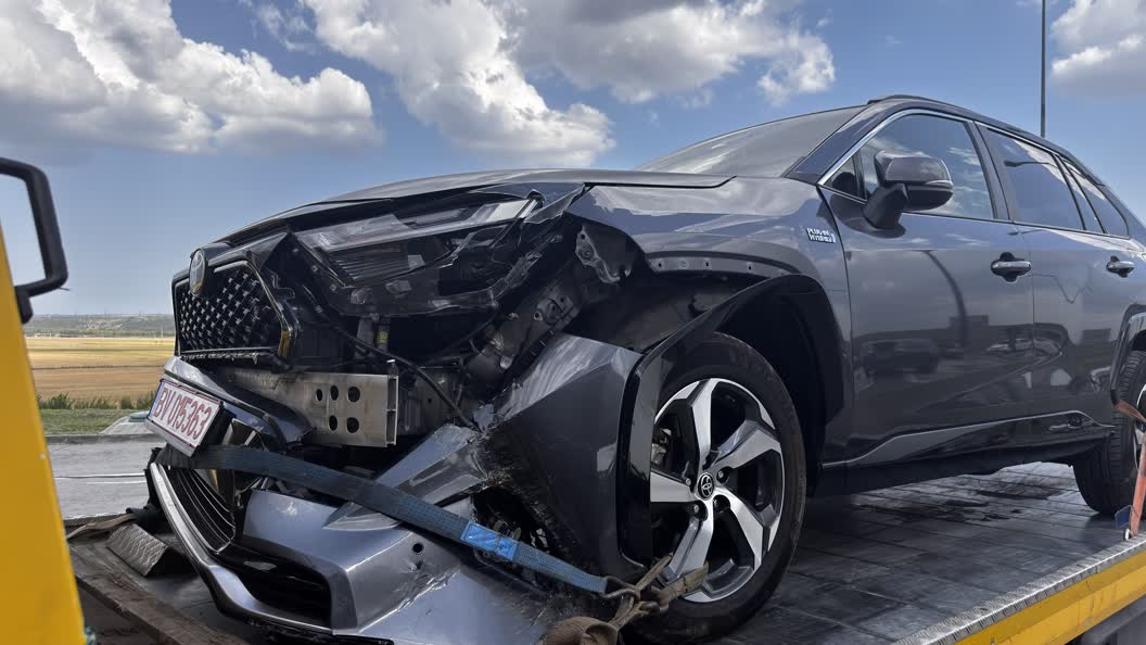The front of our car, destroyed, strapped to a flatbed truck
