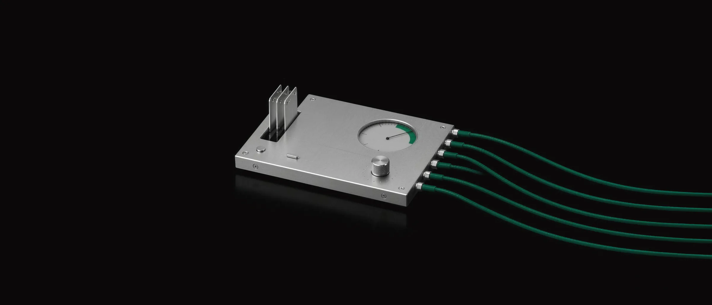 A thin aluminium module with its meter needle rising toward the emerald zone, three product tags standing in its slot and six emerald cables running out of it, one for each shopping feed.
